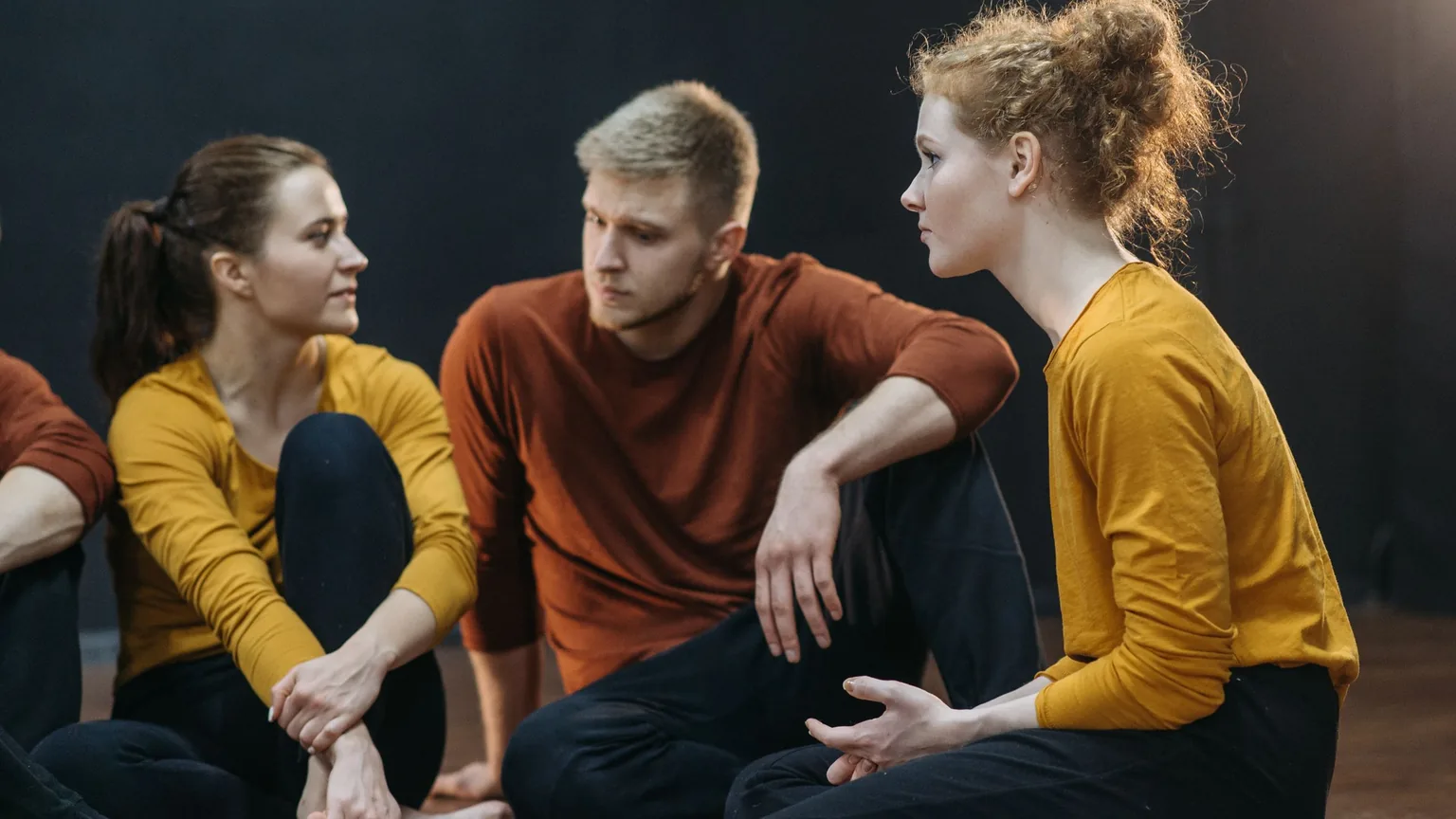 Three members sitting together and talking