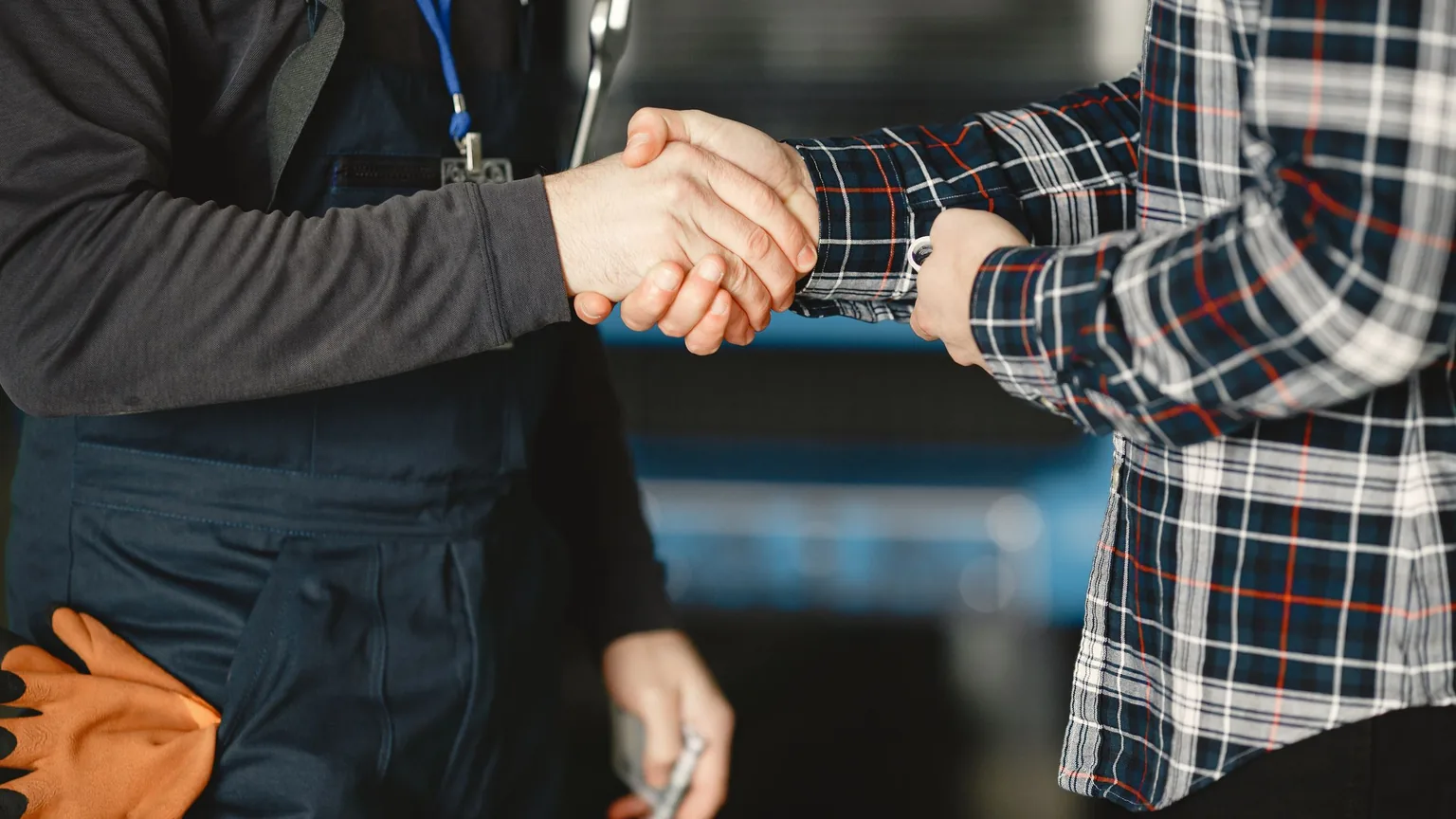 A handshake in the workshop between the shop owner and a rider
