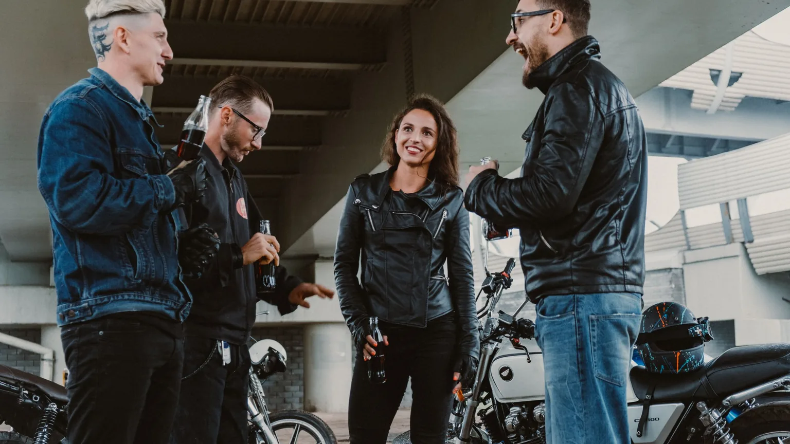 Riders chatting beside their motorcycles at a meet-up point