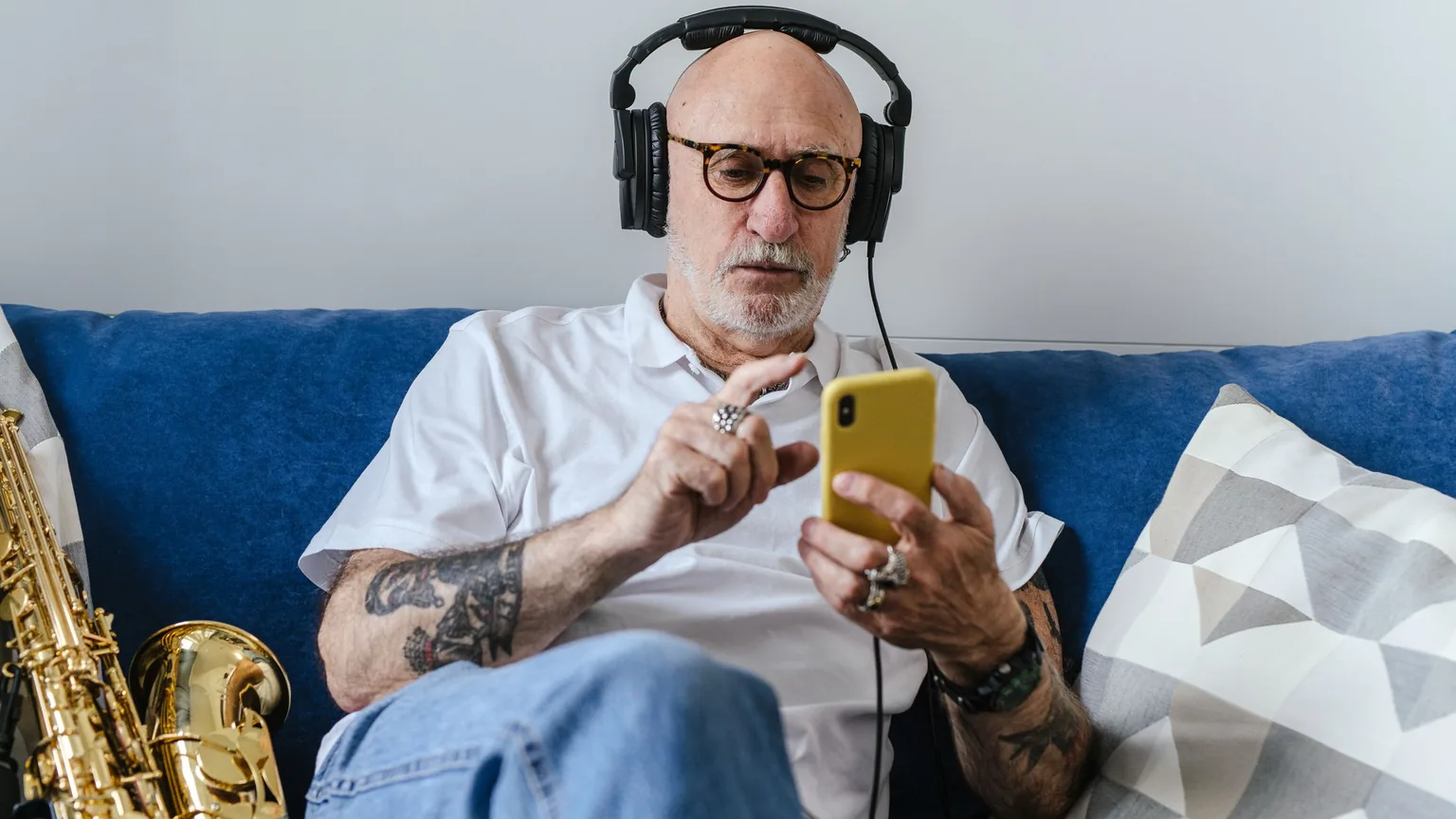 A musician at home checking a message on his phone
