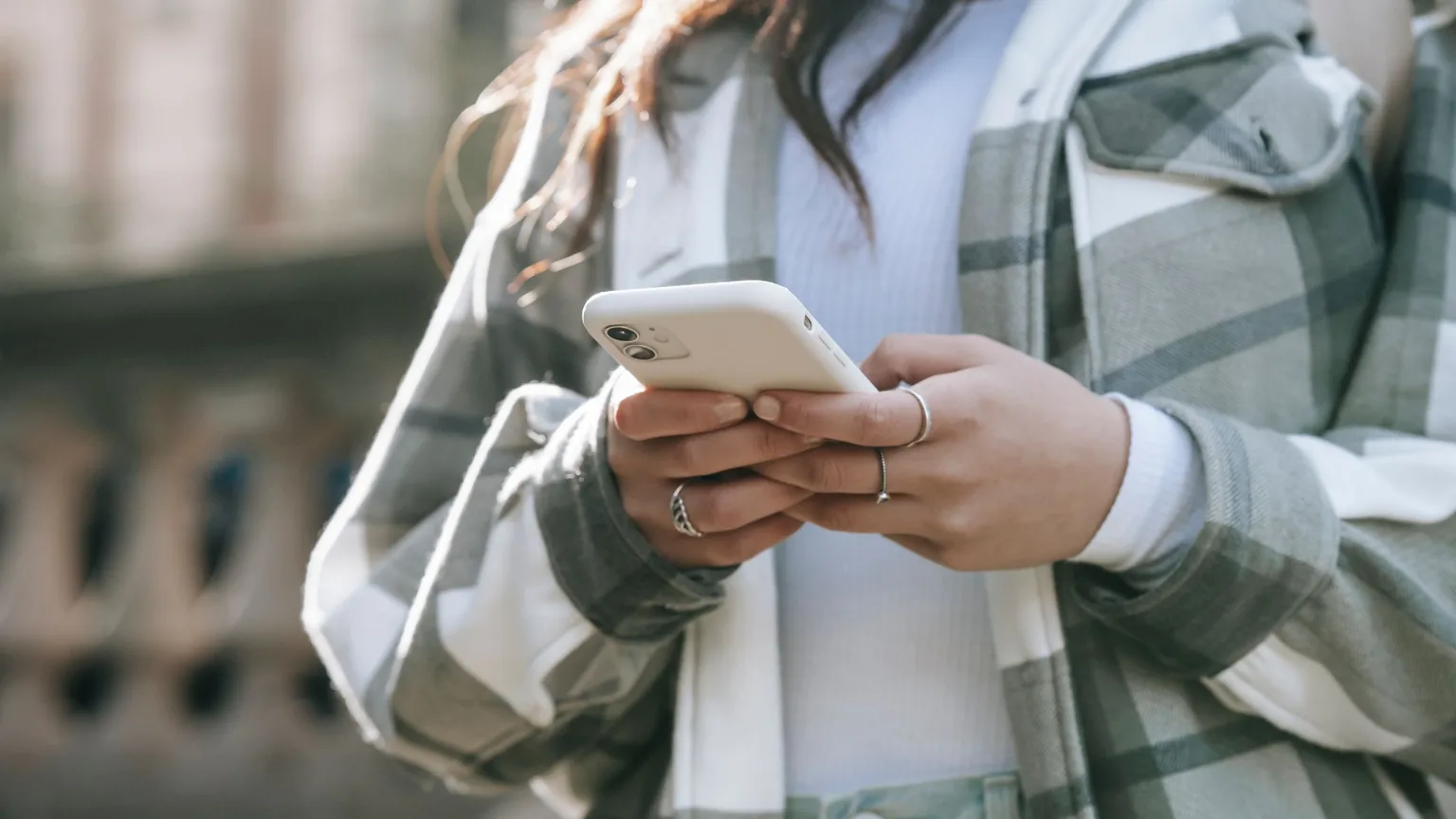 A member checking a reminder on her phone outdoors
