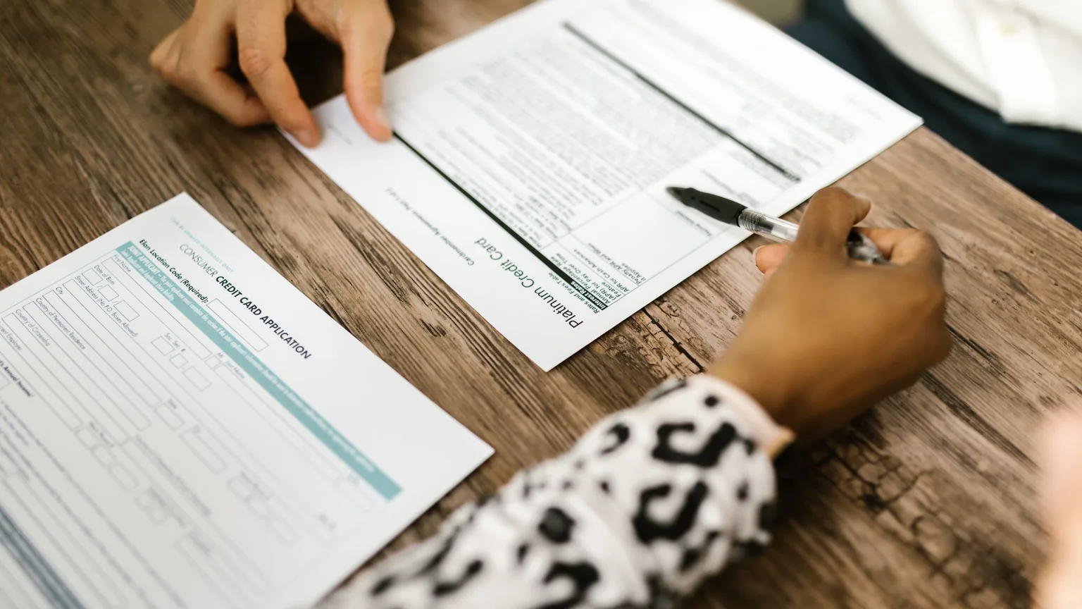A new member filling in a sign-up form at a table