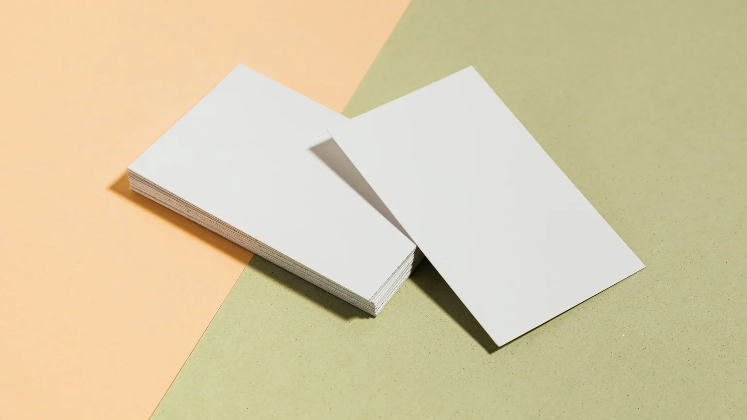 A stack of blank white cards fanned out on a plain surface
