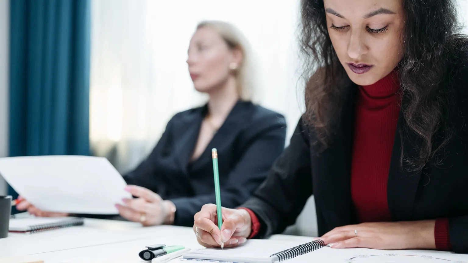 A woman taking notes during a meeting