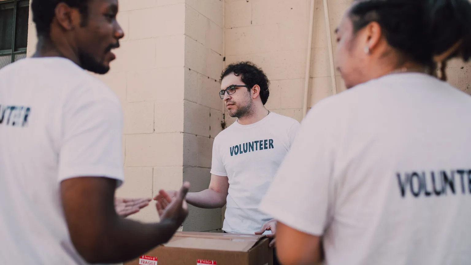 Volunteers in matching shirts talking through the plan face to face