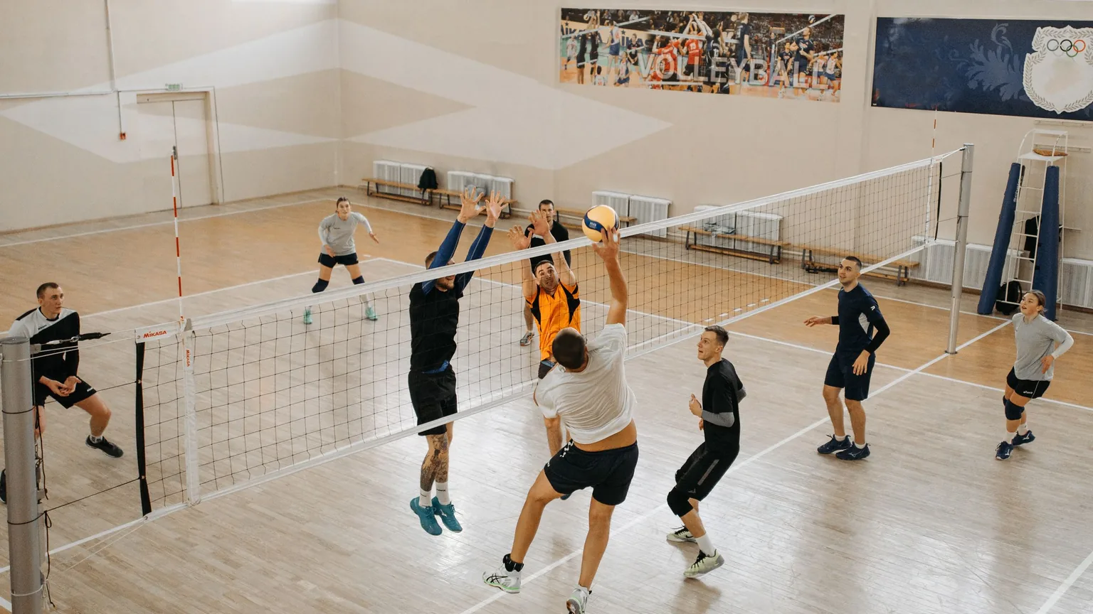 An indoor volleyball game in a community sports hall